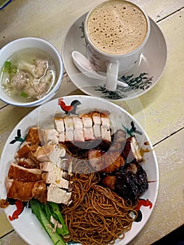 Chinese dishes, food, meal, breakfast. Dry wantan Mee with char siew, BBQ pork, roasted pork, chicken. Dumpling soup