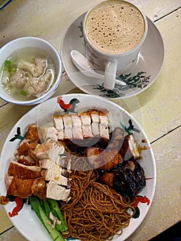 Chinese dishes, food, meal, breakfast. Dry wantan Mee with char siew, BBQ pork, roasted pork, chicken. Dumpling soup photo