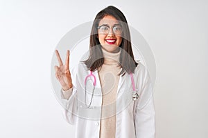 Chinese doctor woman wearing coat and pink stethoscope over isolated white background showing and pointing up with fingers number