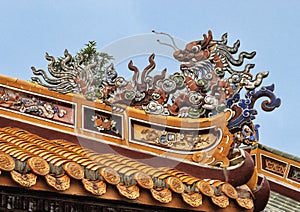 Chinese dragon atop a building in the Tu Duc Royal Tomb complex, Hue, Vietnam