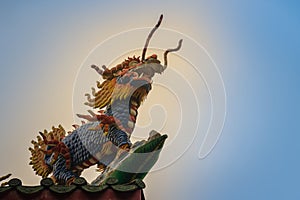 Chinese dragon-headed unicorn statue on the temple roof. Kylin o