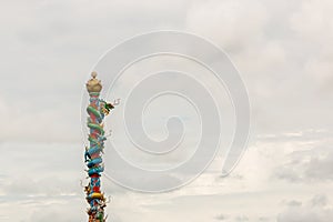 Chinese dragon statue on red pillars cloudy.