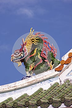 Chinese Dragon statue on the roof.