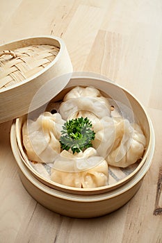 Chinese dumpling in a bamboo steamer box