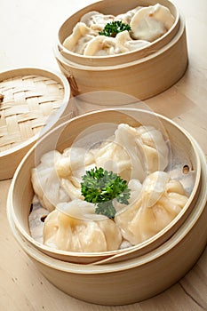 Chinese dumpling in a bamboo steamer box