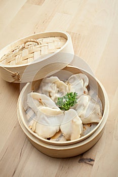 Chinese dumpling in a bamboo steamer box