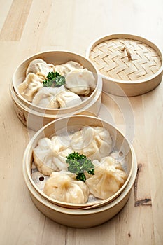 Chinese dumpling in a bamboo steamer box