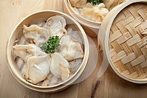 Chinese dumpling in a bamboo steamer box