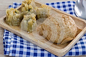 Chinese dumpling and steamed stuff bun on table