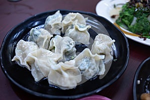 Chinese dumplings in a black plate