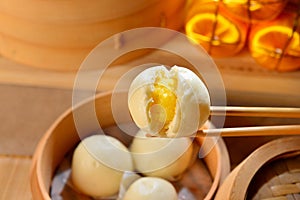 Chinese dumplings with yellow egg inside on bamboo tray