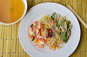 Chinese egg noodle with barbecue pork topping chili paste and soup