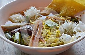 Chinese egg noodle with fish ball and crispy squid in soup