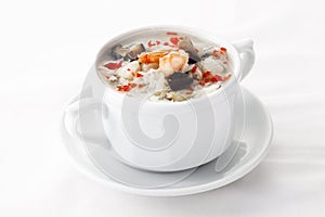 Chinese egg soup with seafood in white bowl