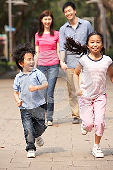 Chinese Family Walking Through Park