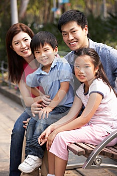 Chinese Family Walking Sitting On Bench In Park