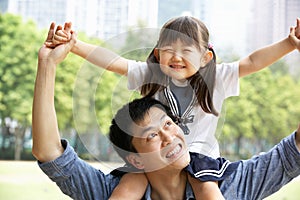 Chinese Father Giving Daughter Ride On Shoulders