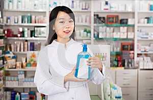 Chinese female pharmacist demonstrating medicines