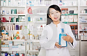 Chinese female pharmacist demonstrating medicines