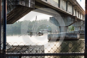 Chinese fisher net under a bridge along the kollam kottapuram waterway photo