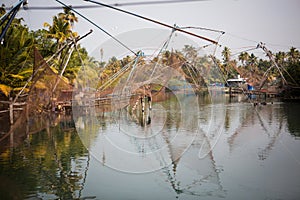 Chinese fishing nets are a tourist attraction in the Indian city of Kochi in Kerala. Large nets on the pier, fishermen and tourist