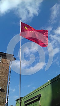 Chinese flag flying on food stall east street market south lodon UK.