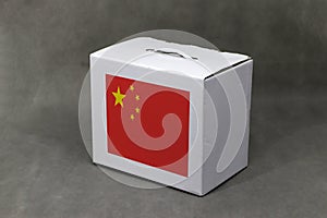Chinese flag on white box, Paper packaging for put products. The concept of China export trading
