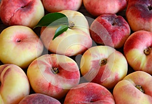 Chinese flat donut peaches also known as Saturn donut, Doughnut peach,Paraguayo as a background.Healthy eating or diet concept.