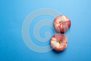 Chinese flat donut peaches flat lay over blue desk
