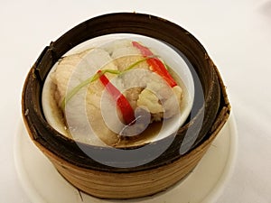 Chinese food in China town, steam fish in soy sauce on bamboo basket, dimsum bamboo tray in the local traditional Chinese restaura