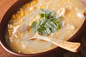 Chinese food: corn soup with chicken and onions close-up. horizontal