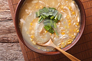 Chinese food: corn soup with chicken and onions close-up. horizontal top view