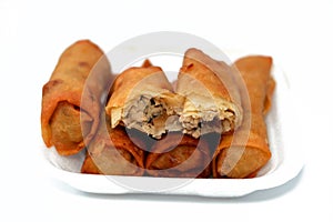 Chinese food cuisine recipe of spring rolls stuffed and filled with chicken pieces and slices of onions fried in deep oil