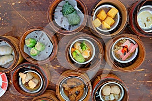 The Chinese food ,A many kind of Dim Sum in bamboo basket on table.