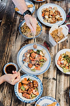 Chinese food noodles, vegetables and beefs on wooden table