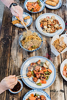 Chinese food noodles, vegetables and beefs on wooden table
