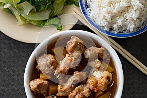 Chinese food of steamed pork ribs with pumpkin and cabbage and bowl of rice horizontal composition