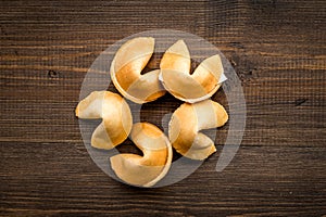 Chinese fortune cookie with prediction on wooden background top view mock up