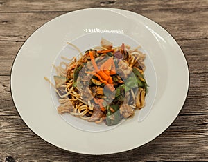 The Chinese fried noodles with squids, an octopus and vegetables.