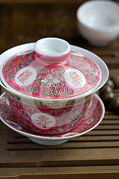 A chinese gaiwan with tea on a tea table