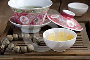 A chinese gaiwan with tea on a tea table