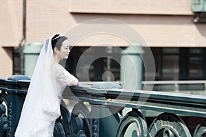 Chinese Girl bride in wedding dress with a beautiful imperial crown