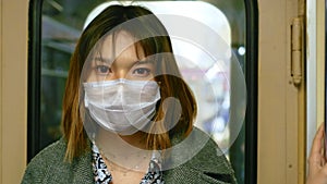 Chinese girl look camera. Respiratory mask face. People china public transport.