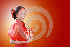 A Chinese girl in a red dress is holding an Qipao envelope