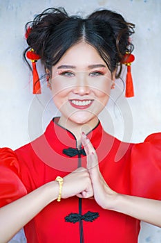A Chinese girl in a red dress is holding an Qipao envelope