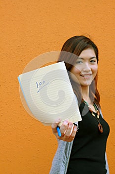 A Chinese girl shows full mark on sheet