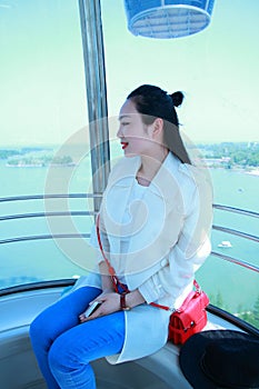 A Chinese girl sits in Ferris wheel