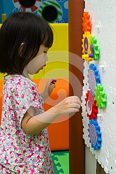 Chinese girl solving puzzle