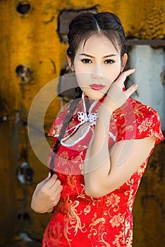 Chinese girl in traditional Chinese cheongsam blessing