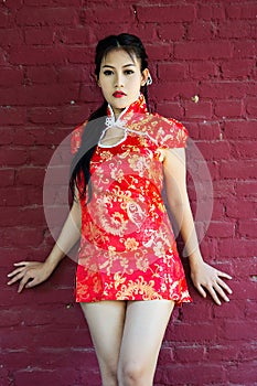 Chinese girl in traditional Chinese cheongsam blessing